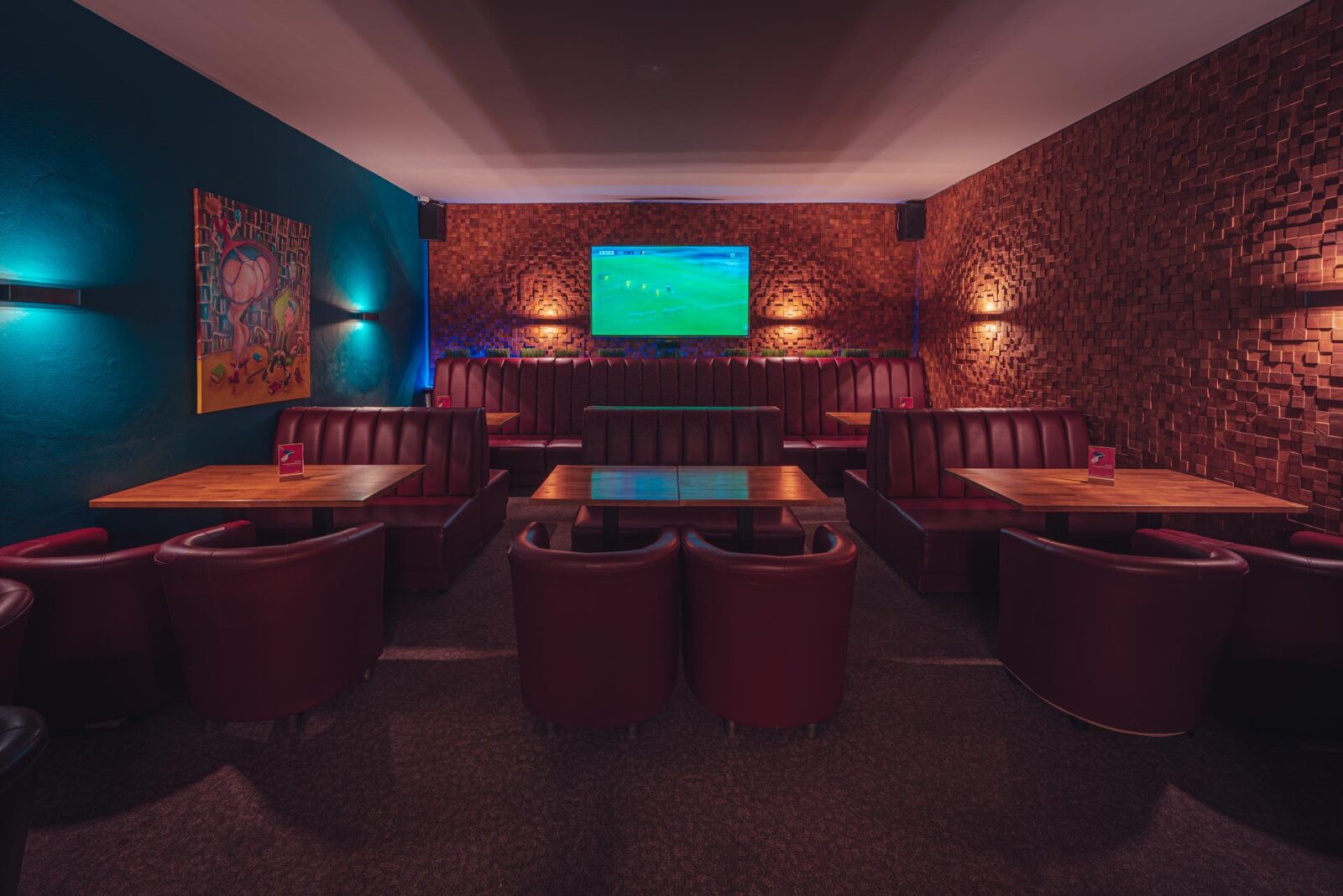 Tables and a screen for live sport at Klub Pictures